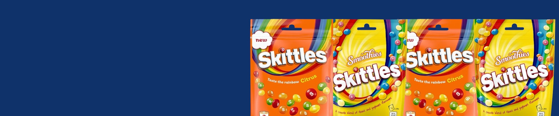 Skittles citrus and smoothies packets on a blue background